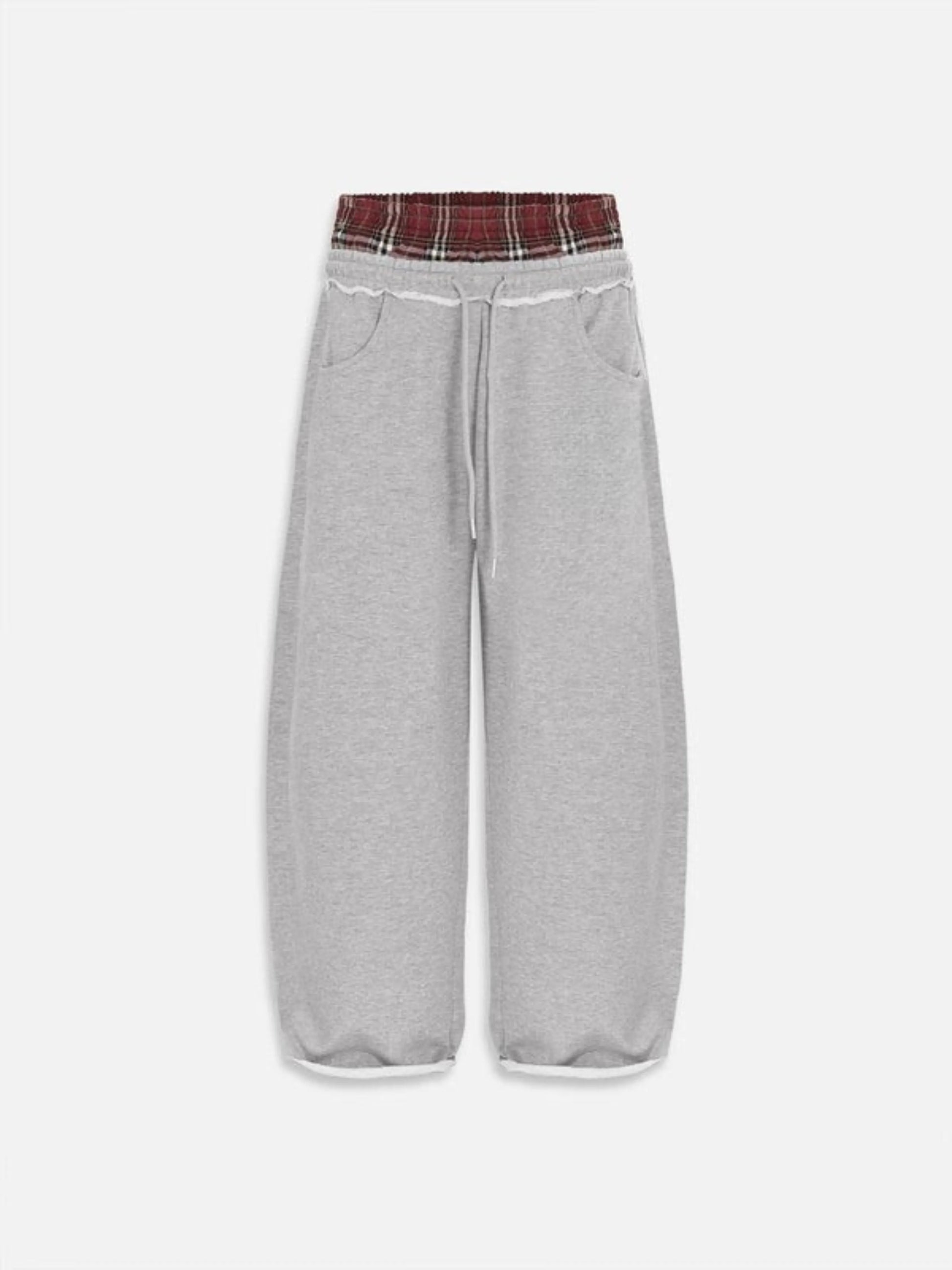 grey boxer waist sweatpants  with a plaid waistband on a white background