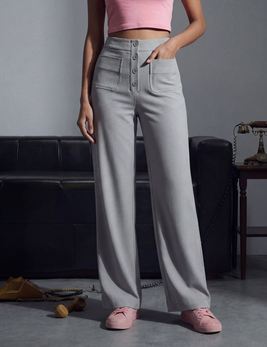 Person wearing grey high-waisted pants and pink shoes.