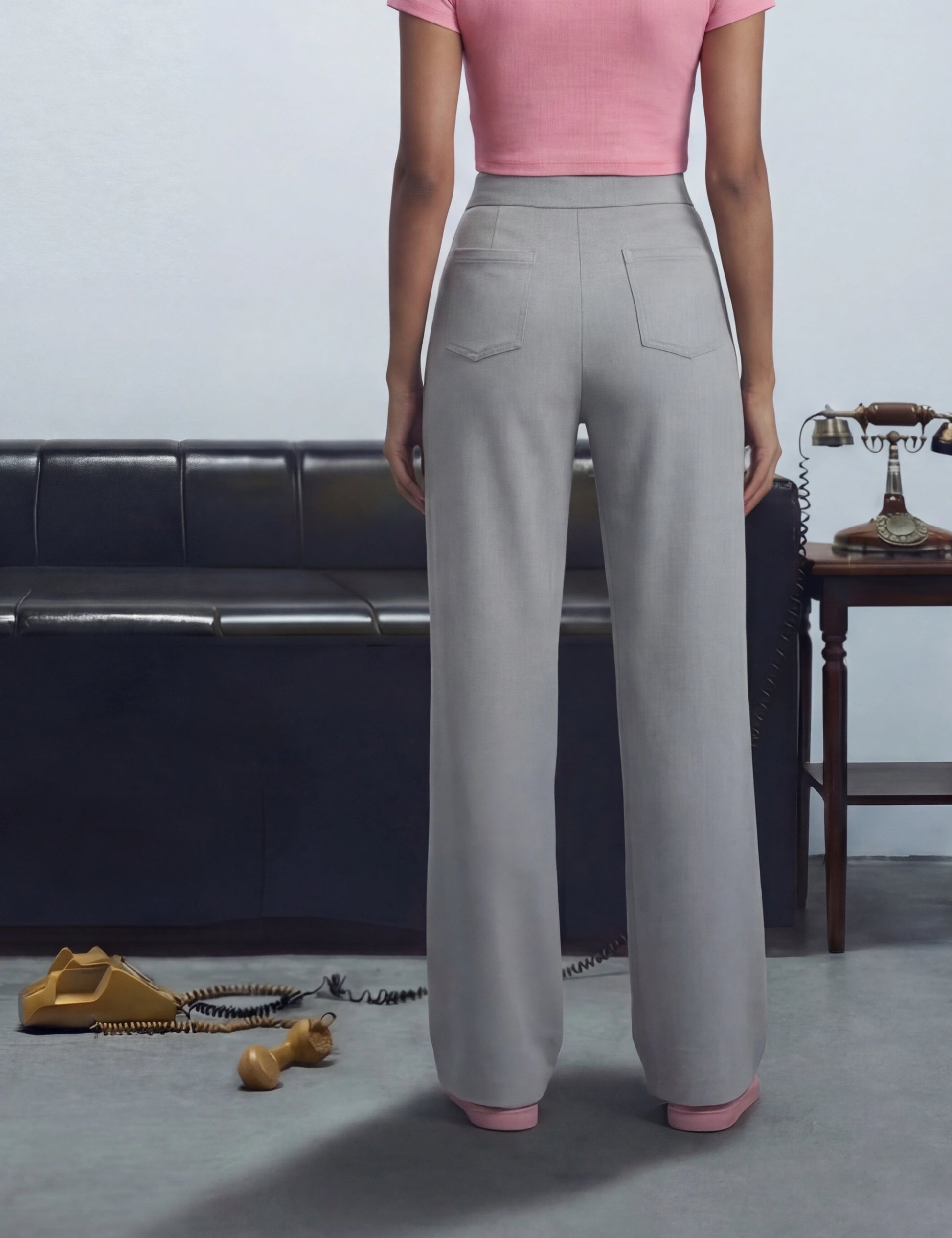 Person wearing grey wide-leg pants and pink top 