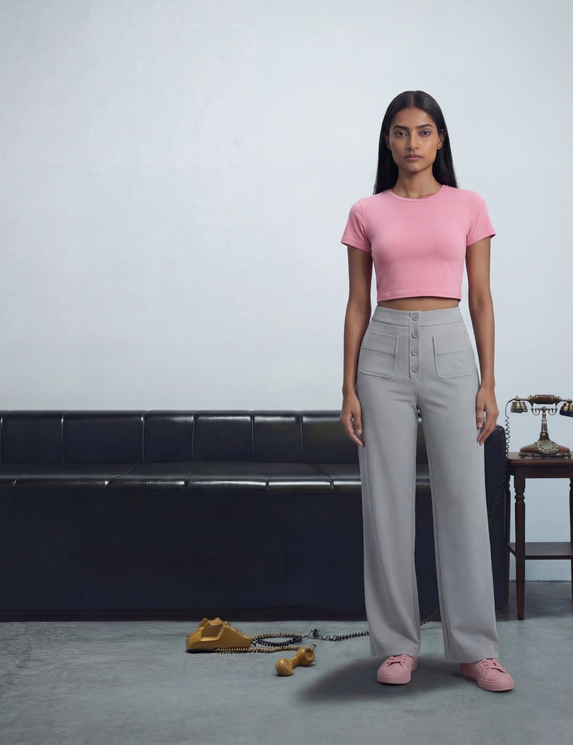 Woman in pink top and grey pants 