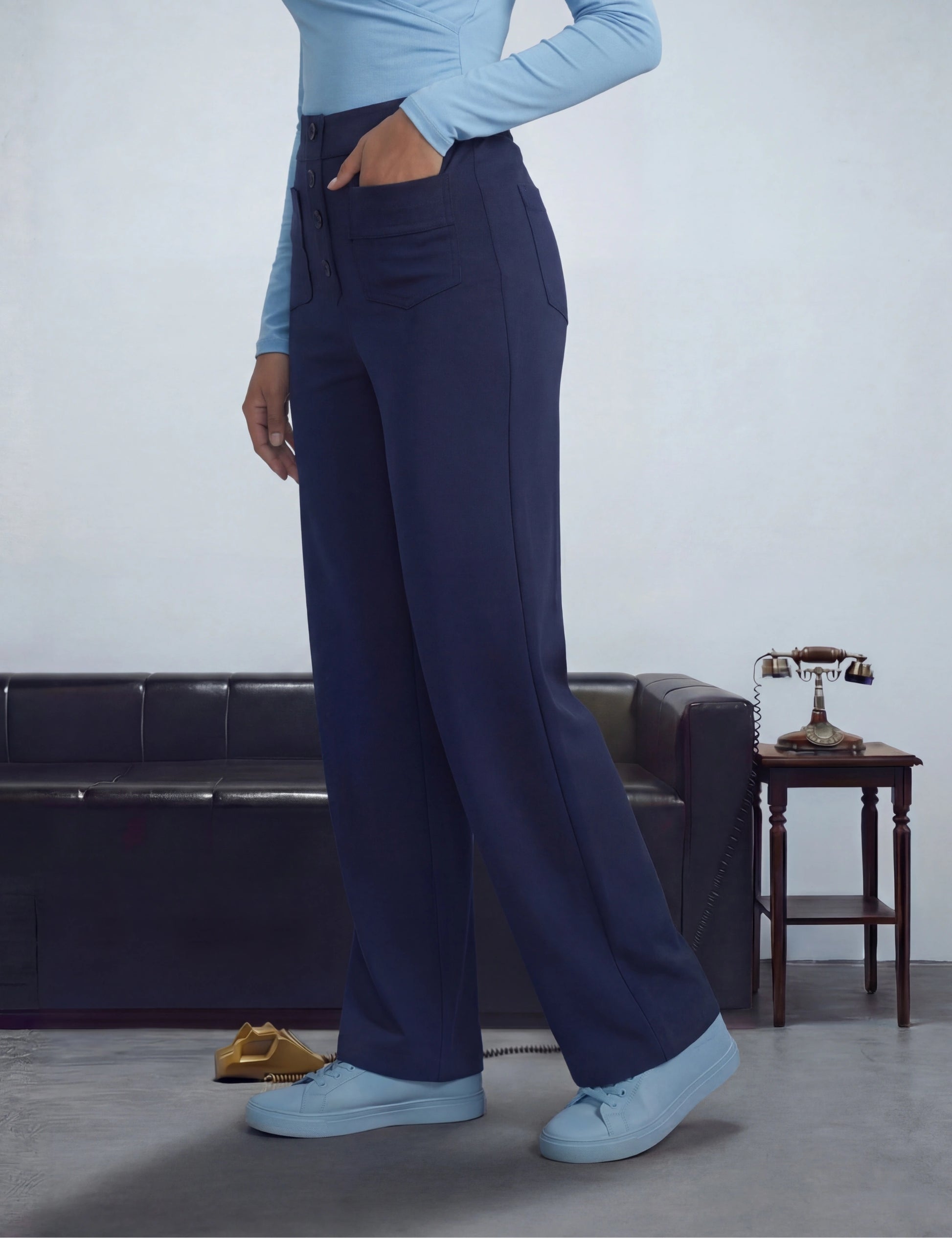 Person wearing navy pants and light blue top 