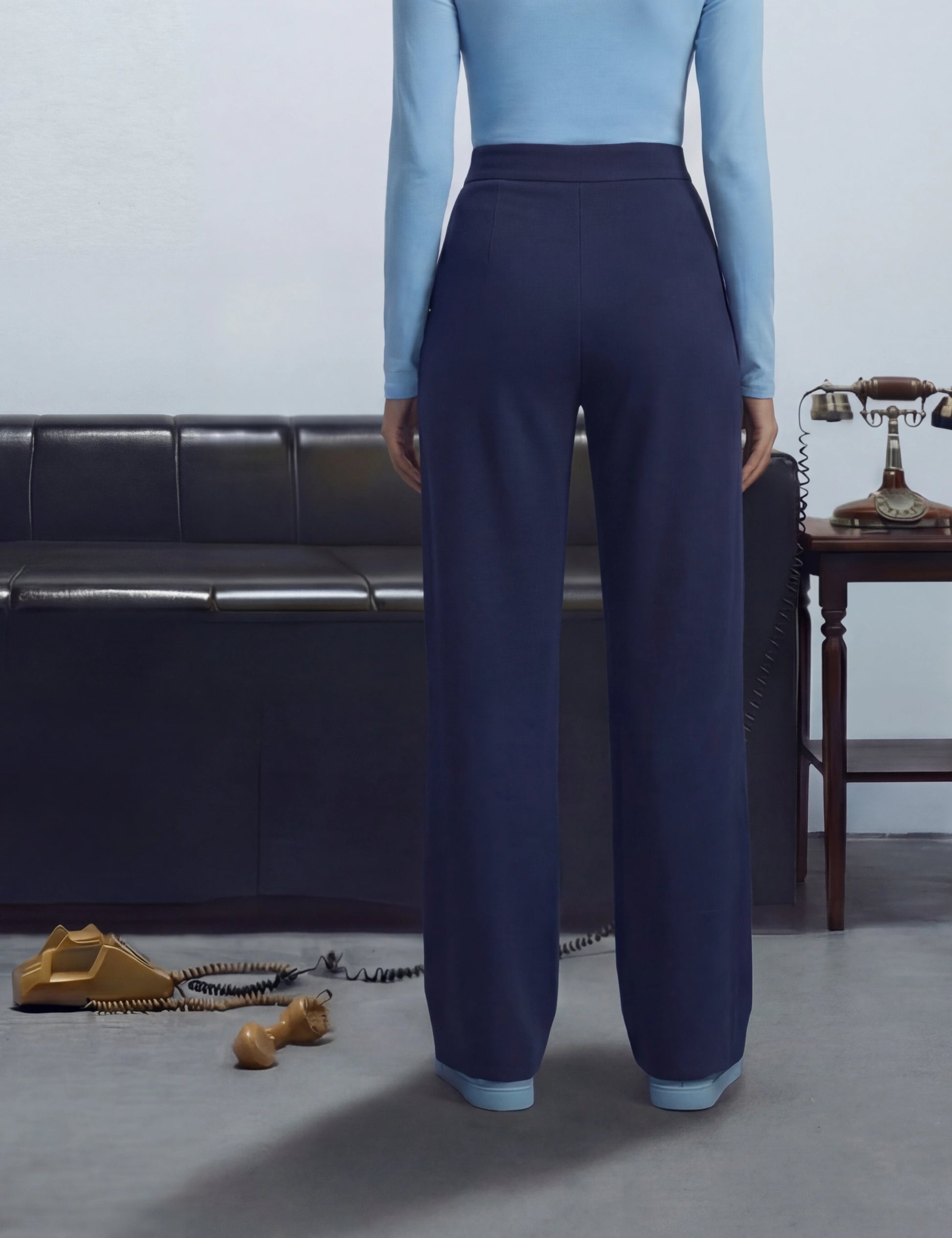 Person wearing a light blue top and dark blue pants