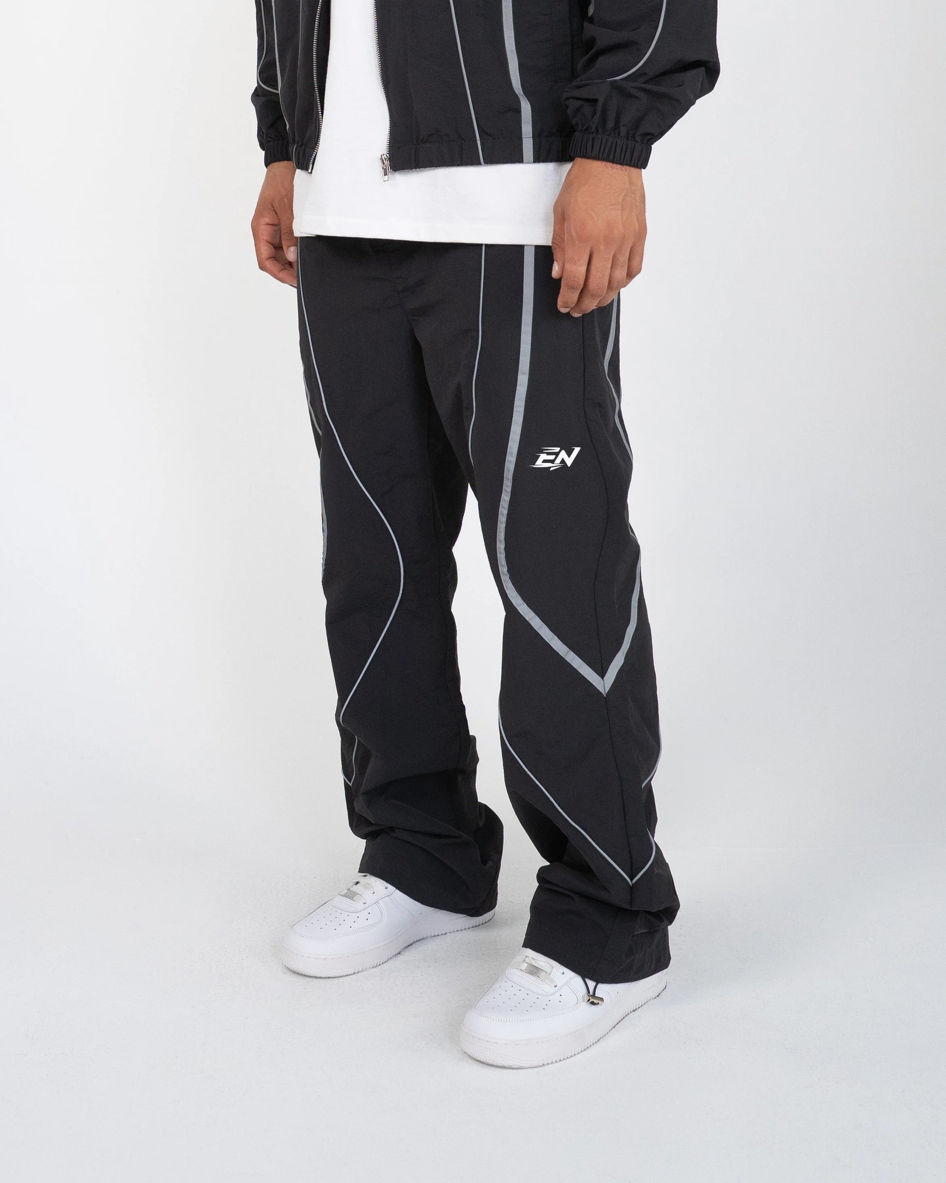 The Black pant delivers a structured yet lightweight feel, while the relaxed-fit track pants ensure fluid movement and all-day comfort. 