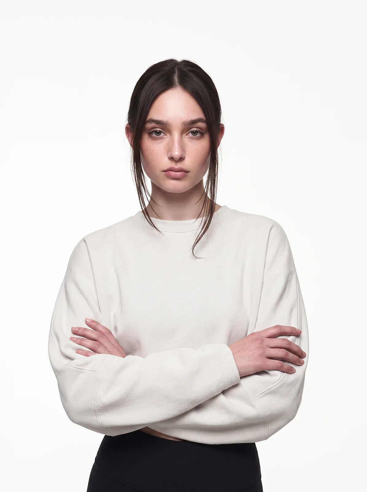 Woman wearing white cult cover crop tee