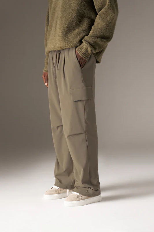 Kyoto Khaki Cargo Pant is a modern utility essential designed with a relaxed wide-leg silhouette for effortless everyday wear. Crafted with a technical, structured fabric, these cargo pants balance durability with comfort, making them ideal for contemporary streetwear and elevated casual styling.
