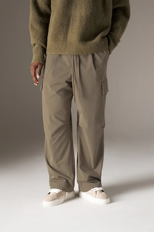 Kyoto Khaki Cargo Pant is a modern utility essential designed with a relaxed wide-leg silhouette for effortless everyday wear. Crafted with a technical, structured fabric, these cargo pants balance durability with comfort, making them ideal for contemporary streetwear and elevated casual styling.