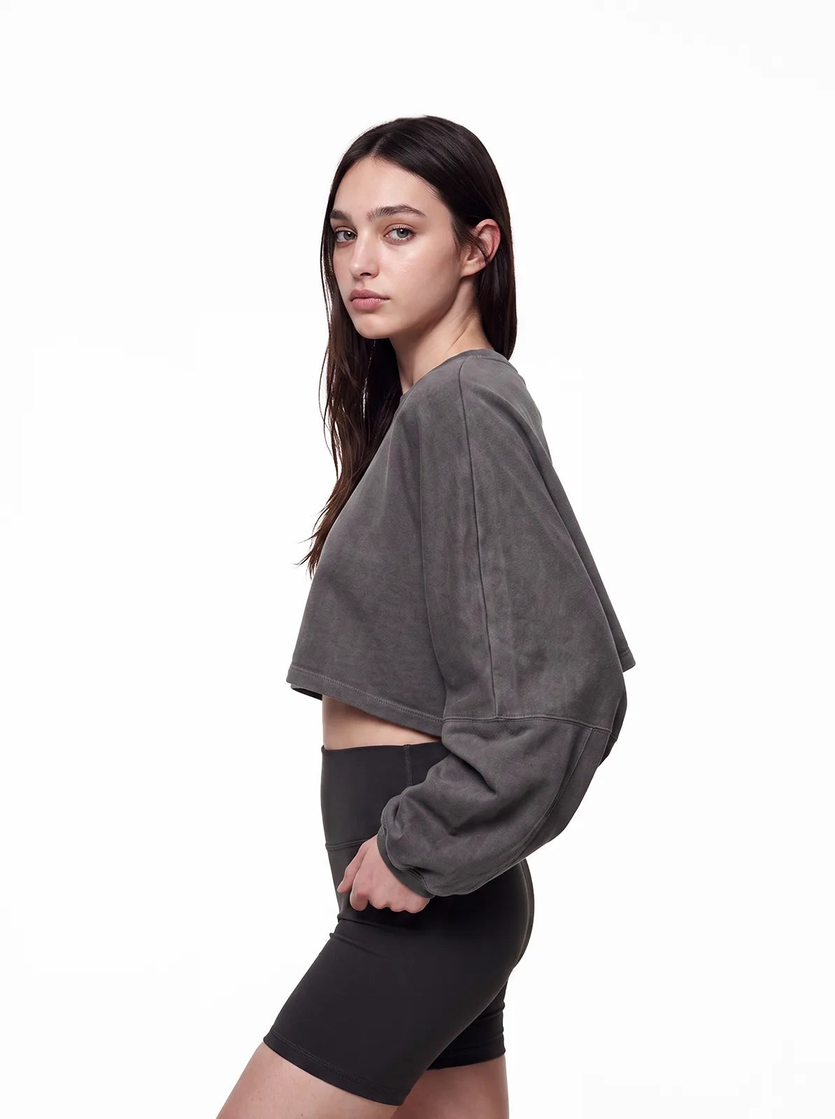 Woman wearing dark grey cult cover crop tee