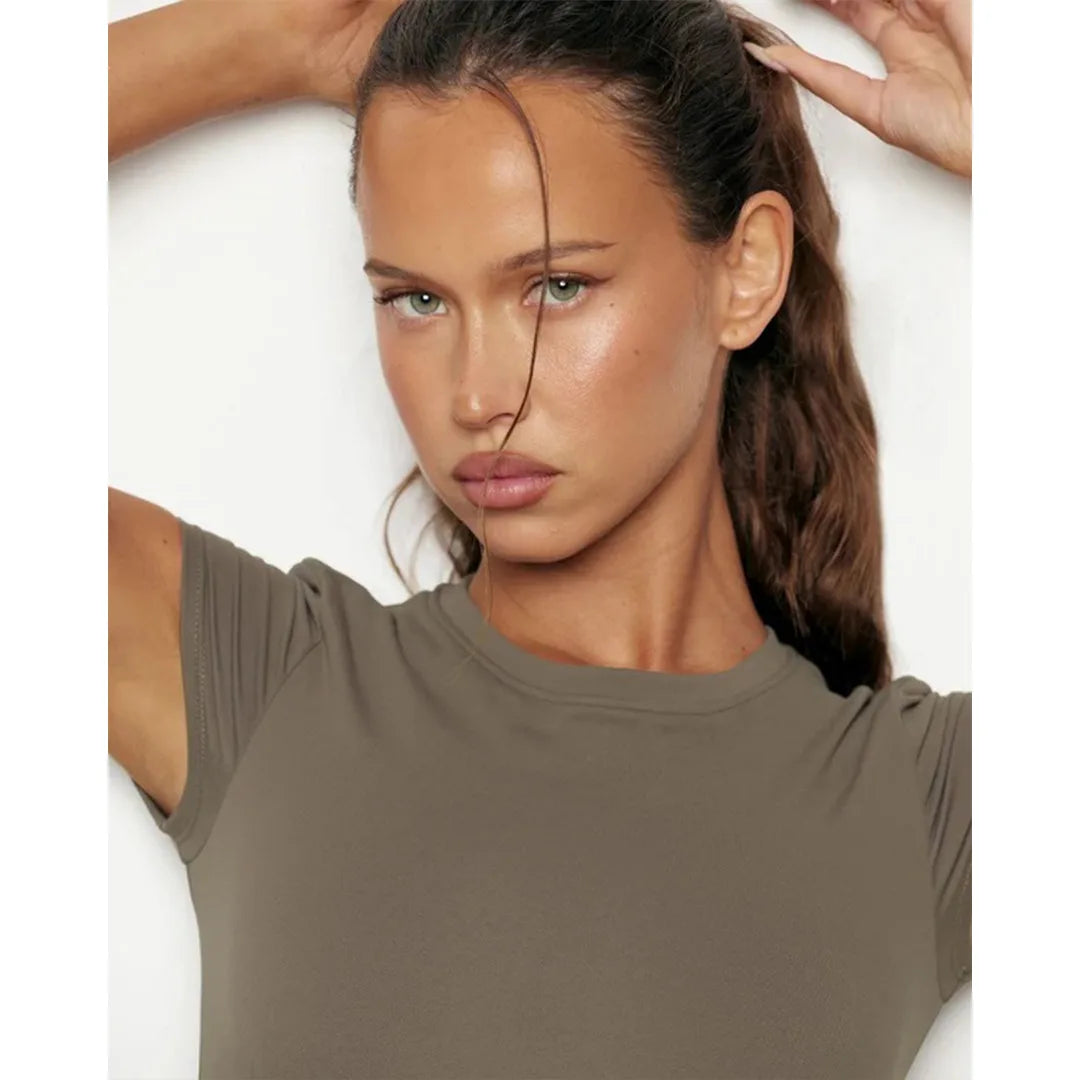 Woman wearing a brown t-shirt against a white background