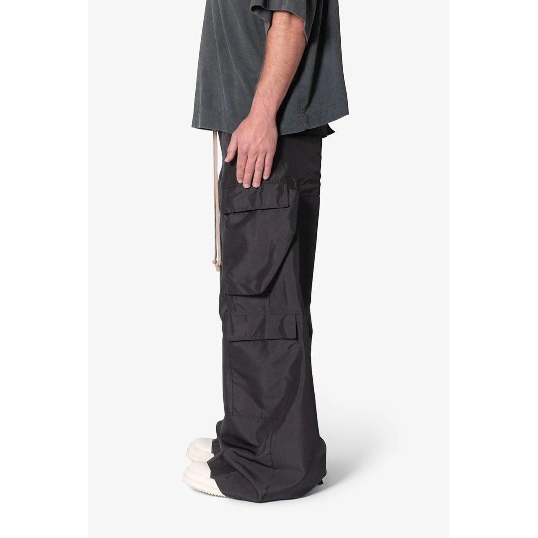 Person wearing dark gray cargo pants on a white background