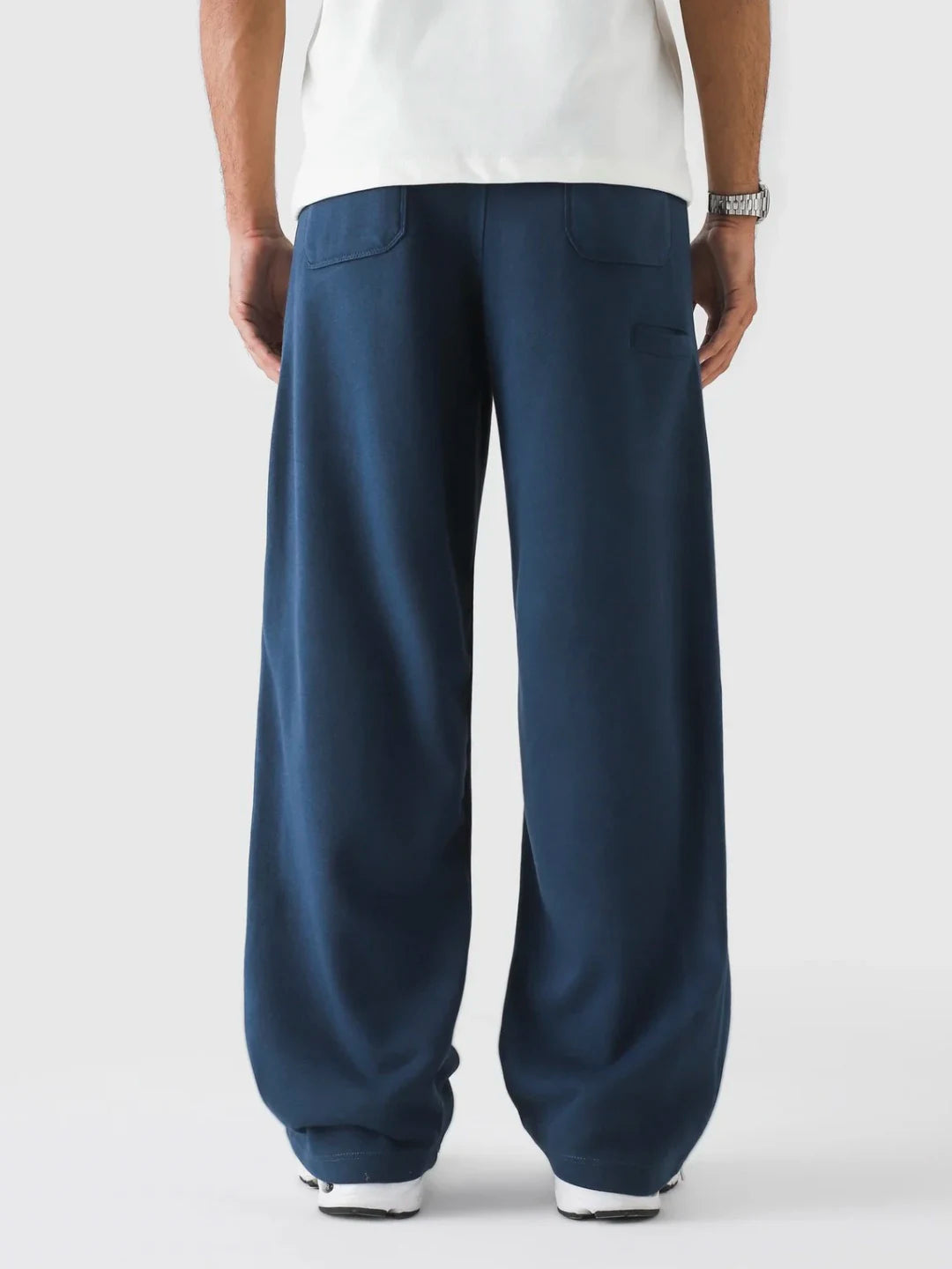 Navy blue wide-leg pants worn by a person on a white background