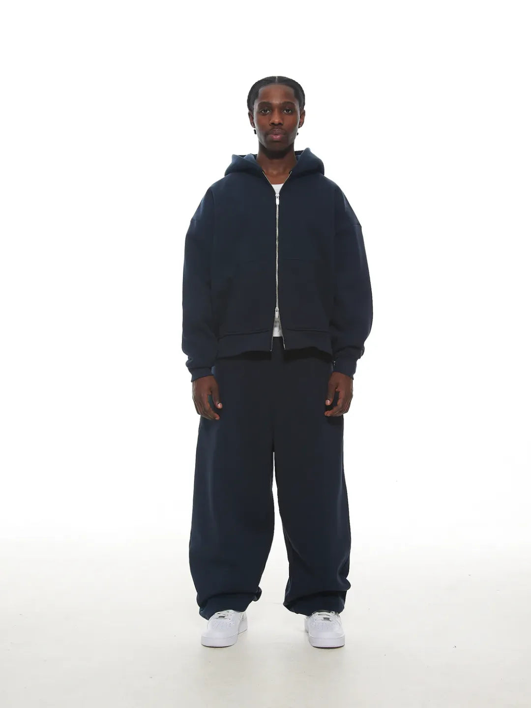Person wearing a navy blue zip-up jacket