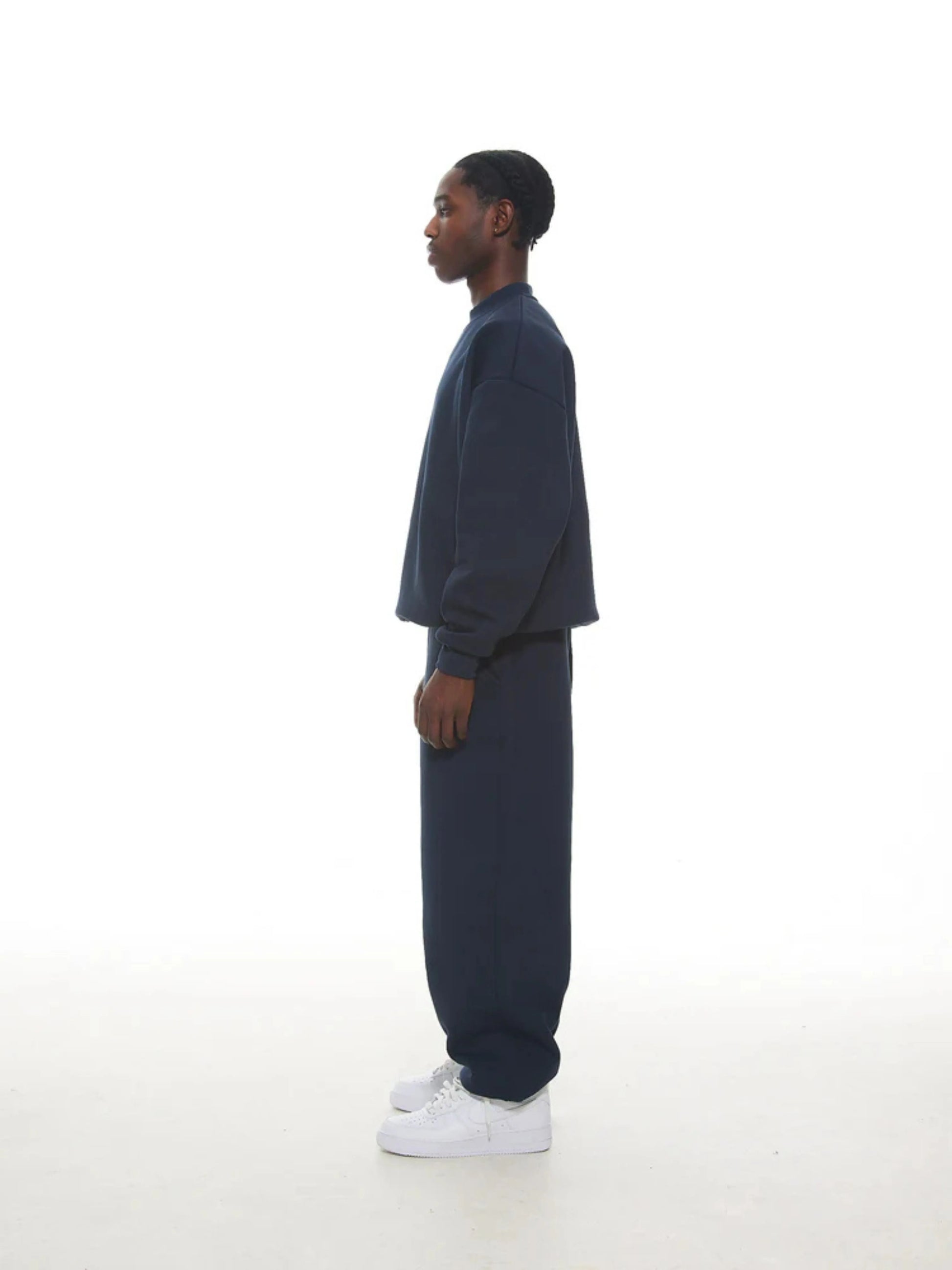 Person wearing a navy sweatshirt and sweatpants set