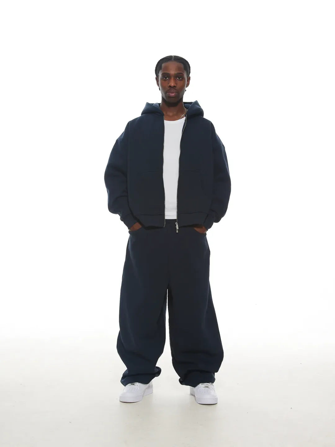 Person wearing a navy blue zip-up jacket