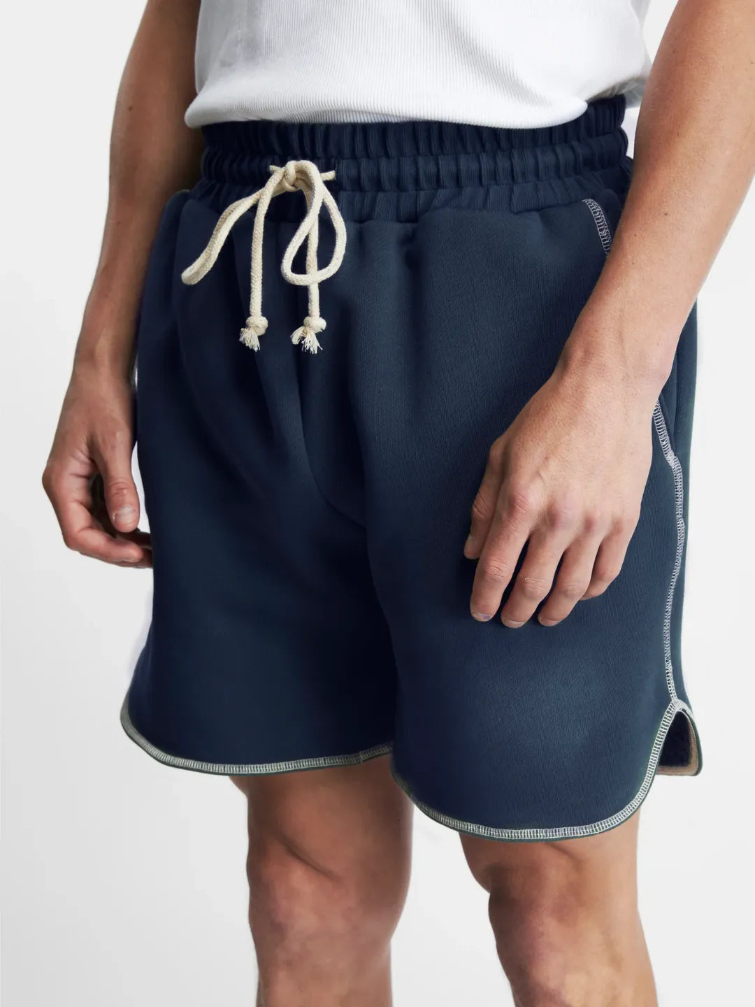 Navy running shorts with a white drawstring on a plain background