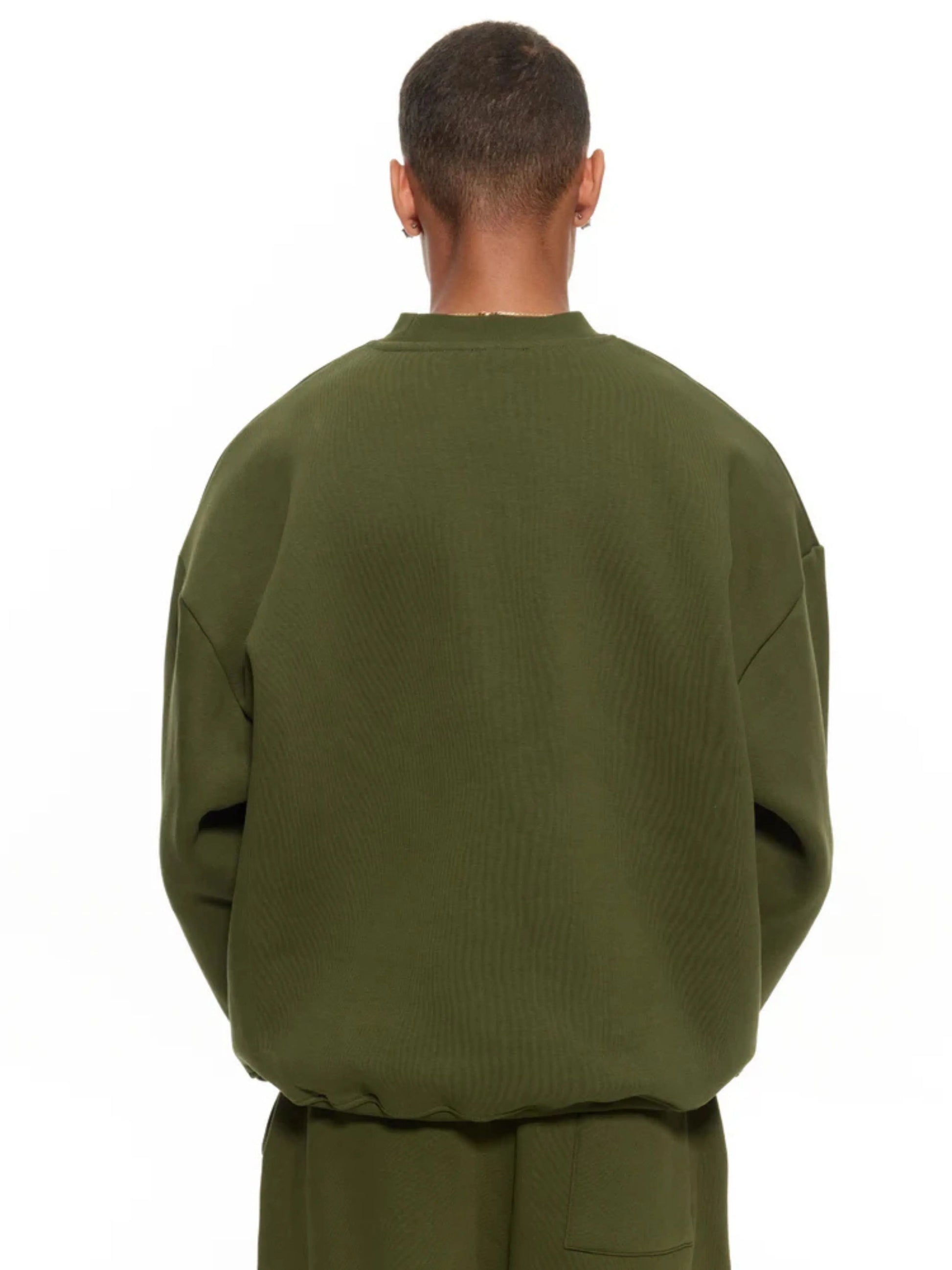 Person wearing a olive sweatshirt and sweatpants set