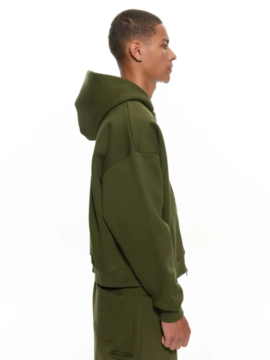 Person wearing a olive zip-up jacket