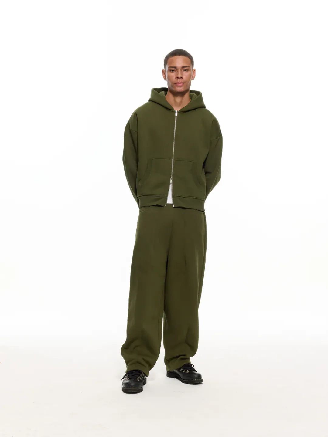 Person wearing a olive zip-up jacket