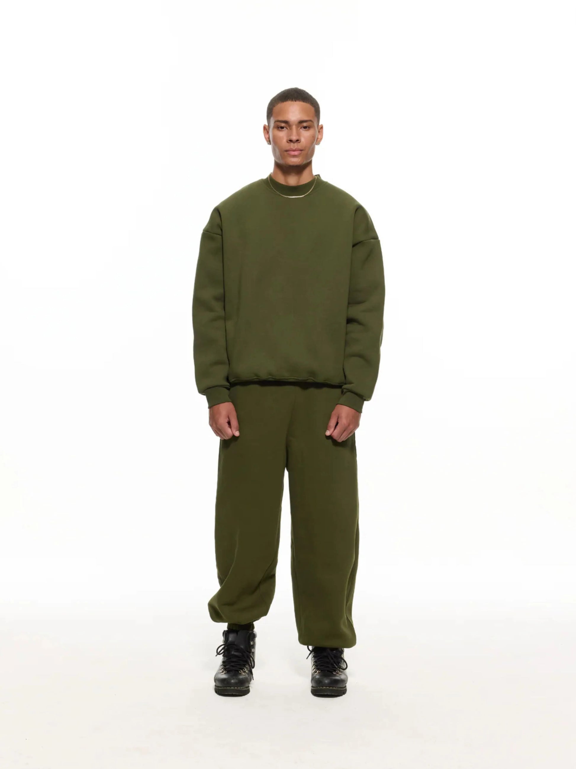 Person wearing olive sweatshirt and sweatpants set