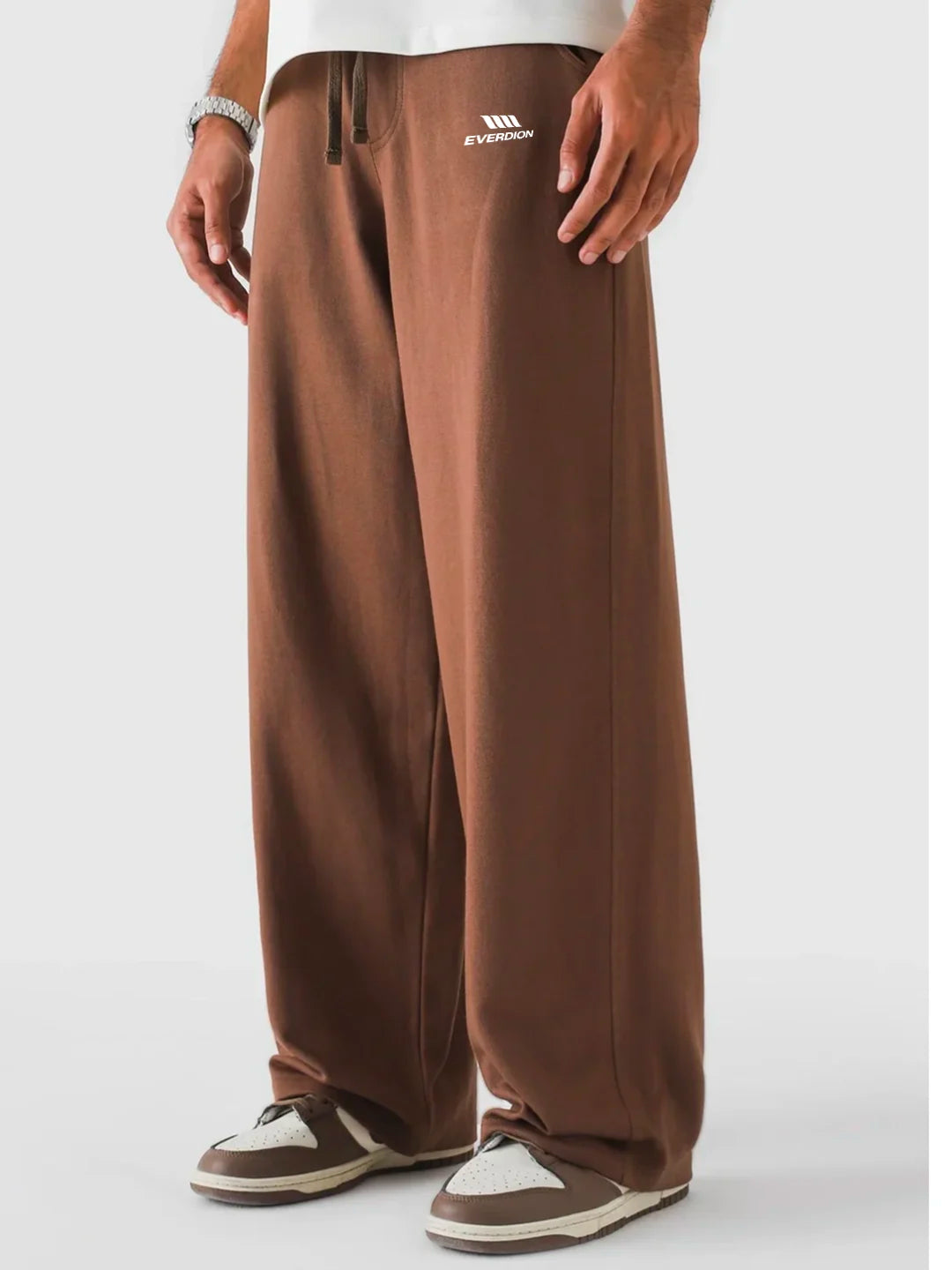 Brown pants with a visible brand logo on a white background
