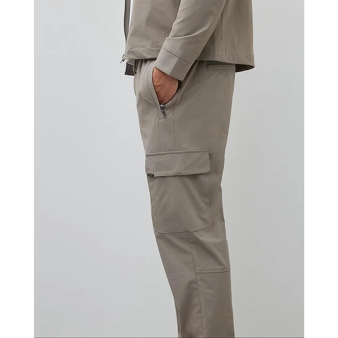 Beige pants worn by a person on a light gray background