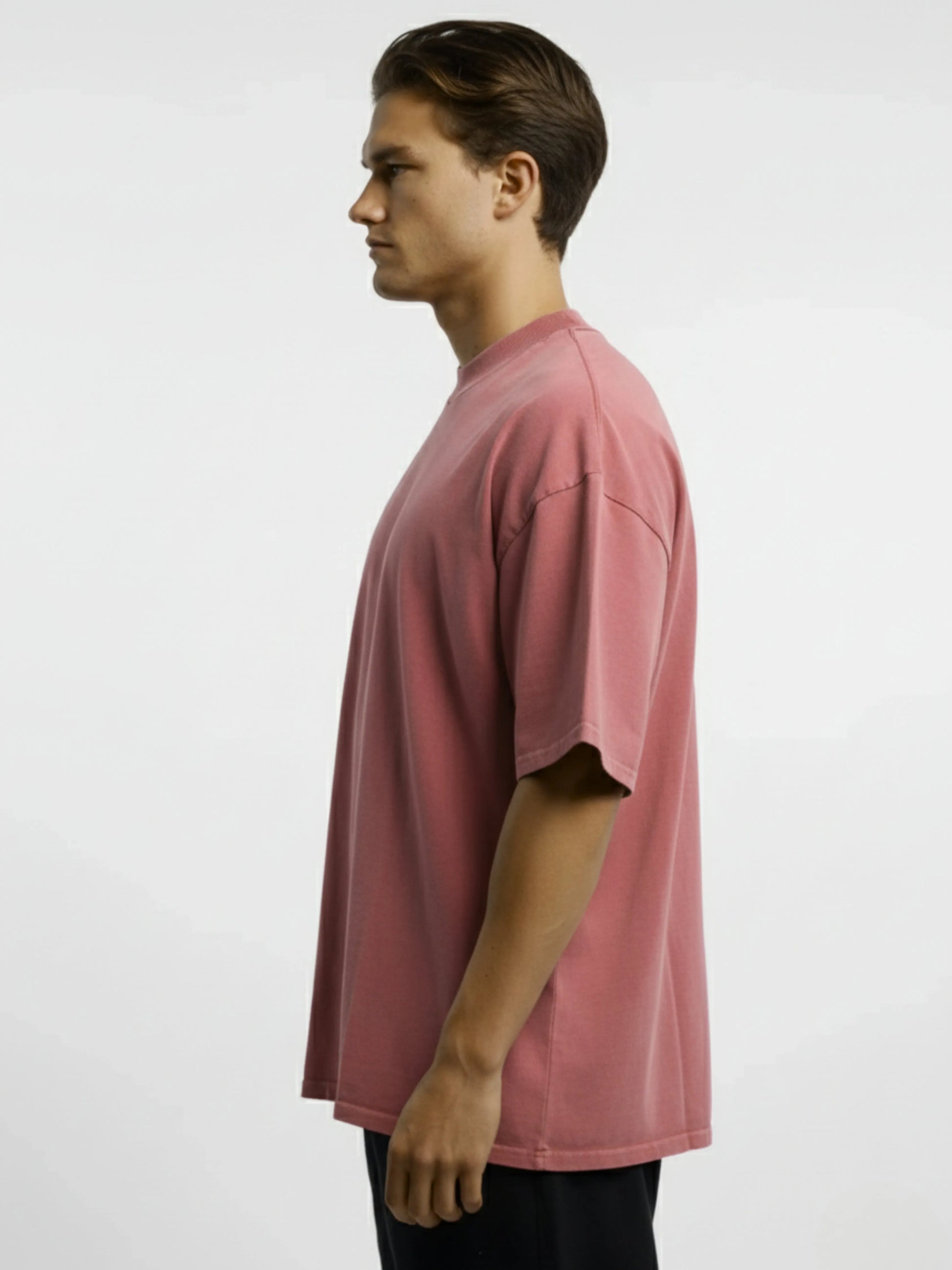 Man wearing a pink t-shirt against a white background