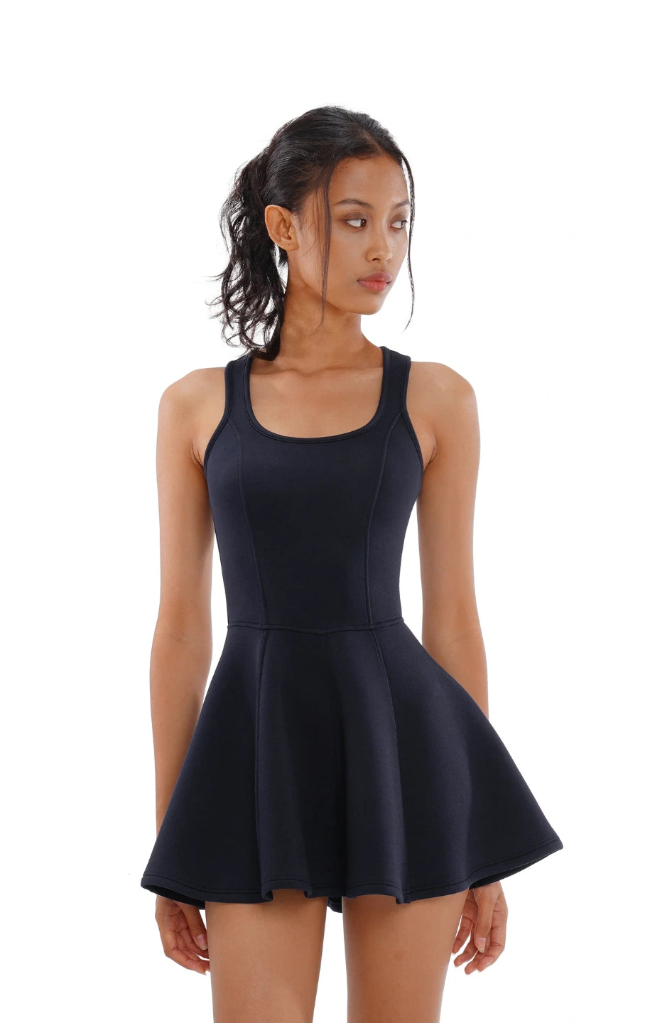 Woman wearing a black sleeveless dress on a white background
