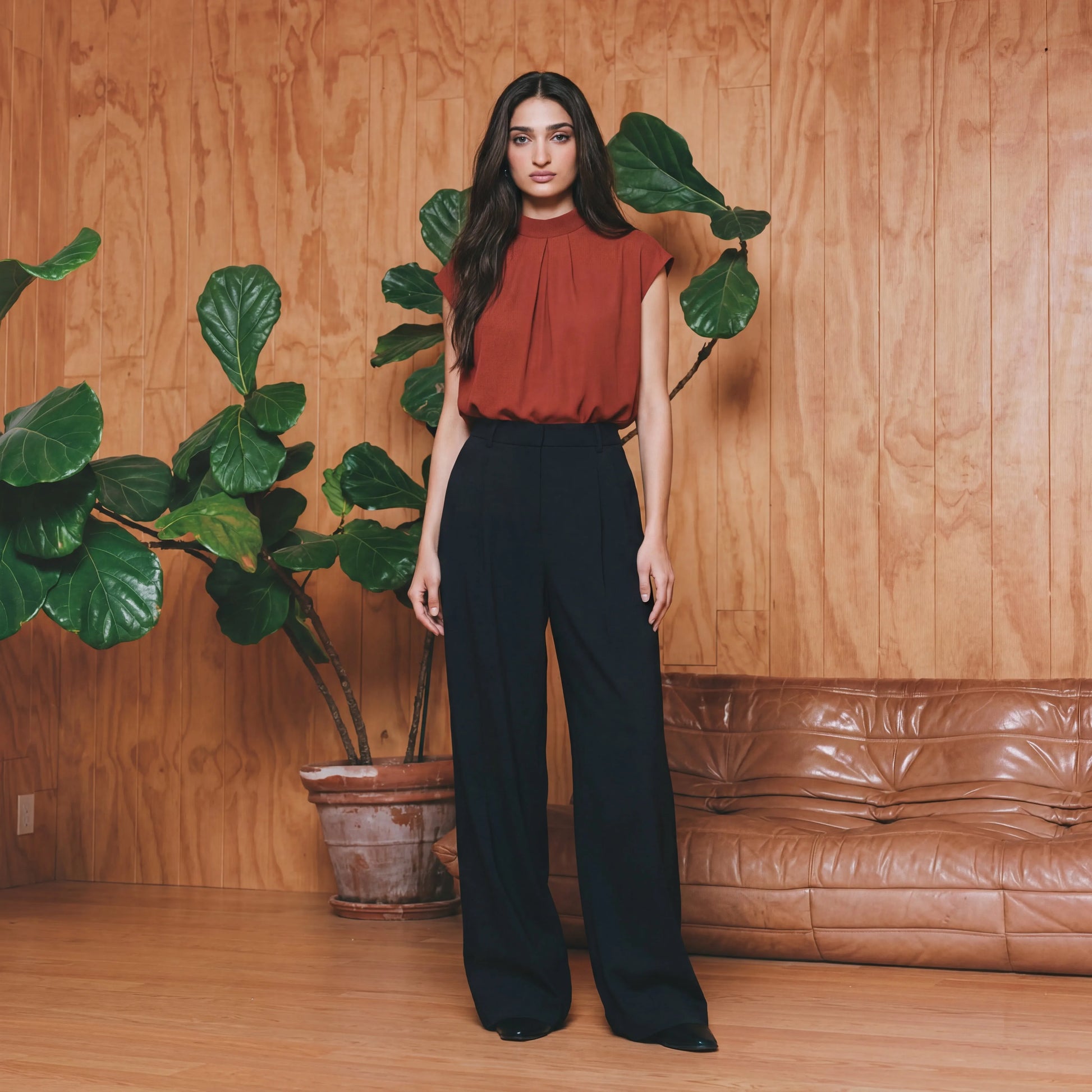 Woman in a red work top and black pants 