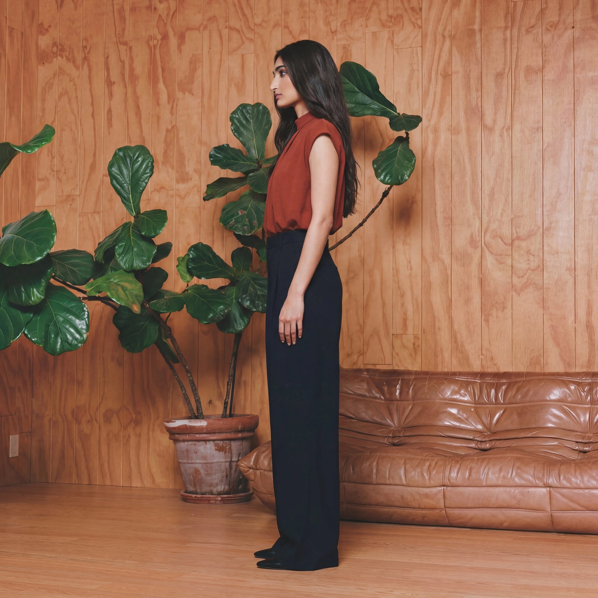 Woman in a red work top and black pants 