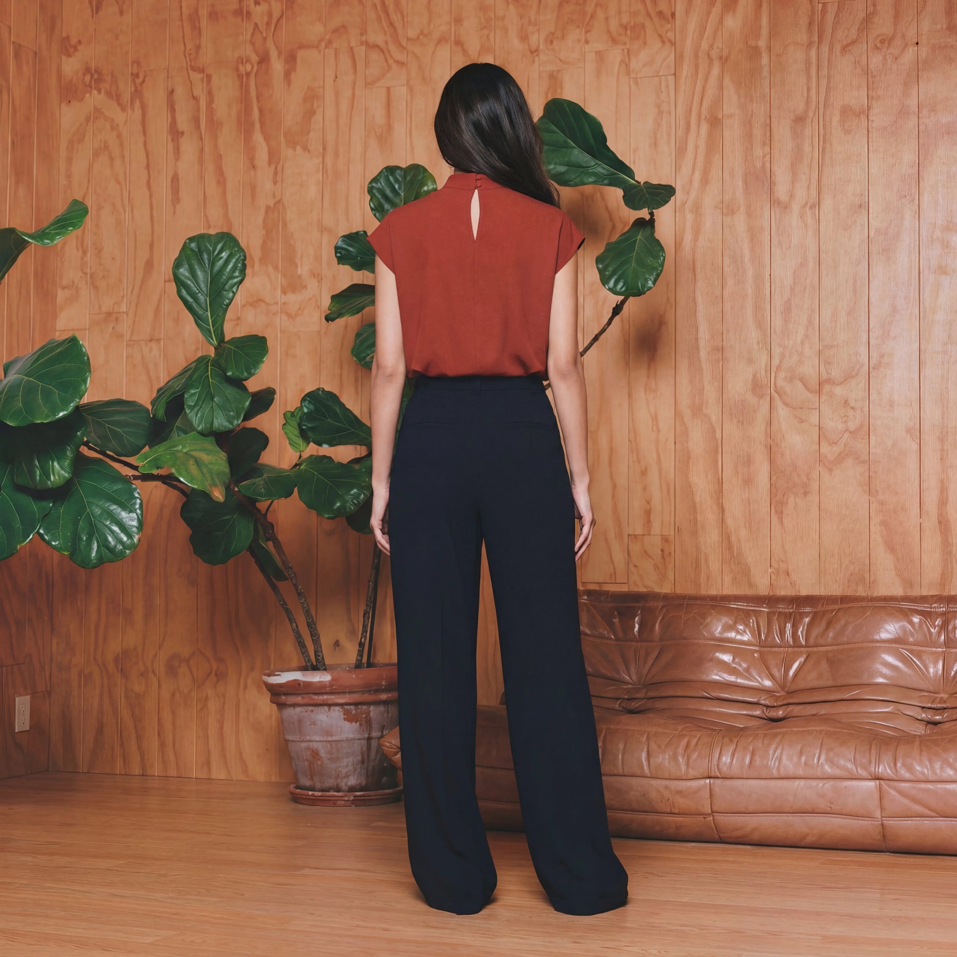 Woman in a red work top and black pants 