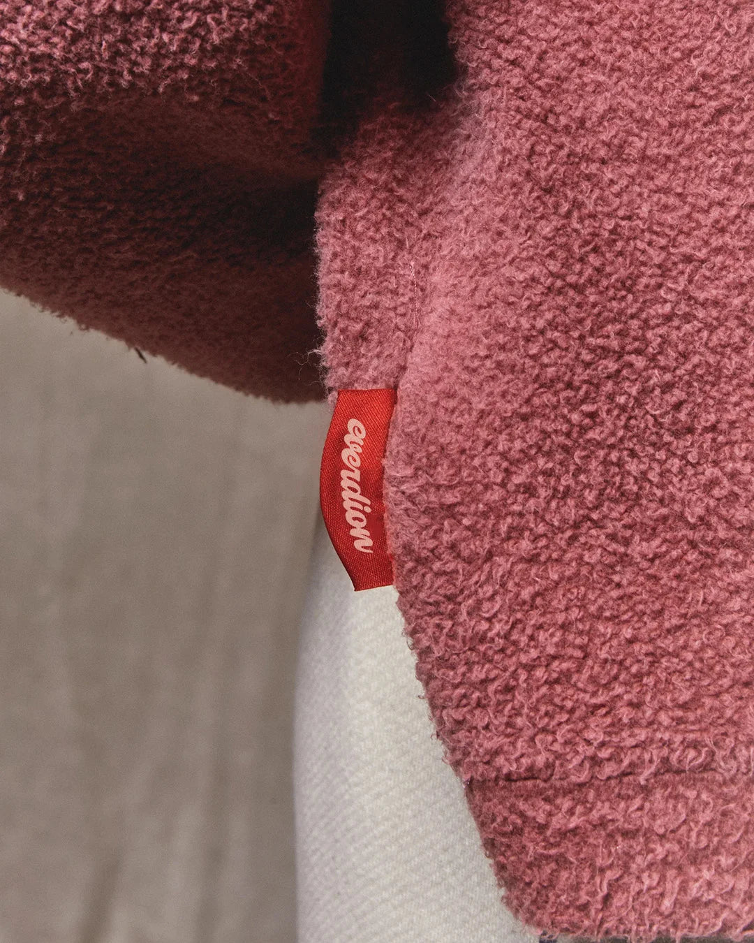 Close-up of a pink textured product with a red label on a gray background