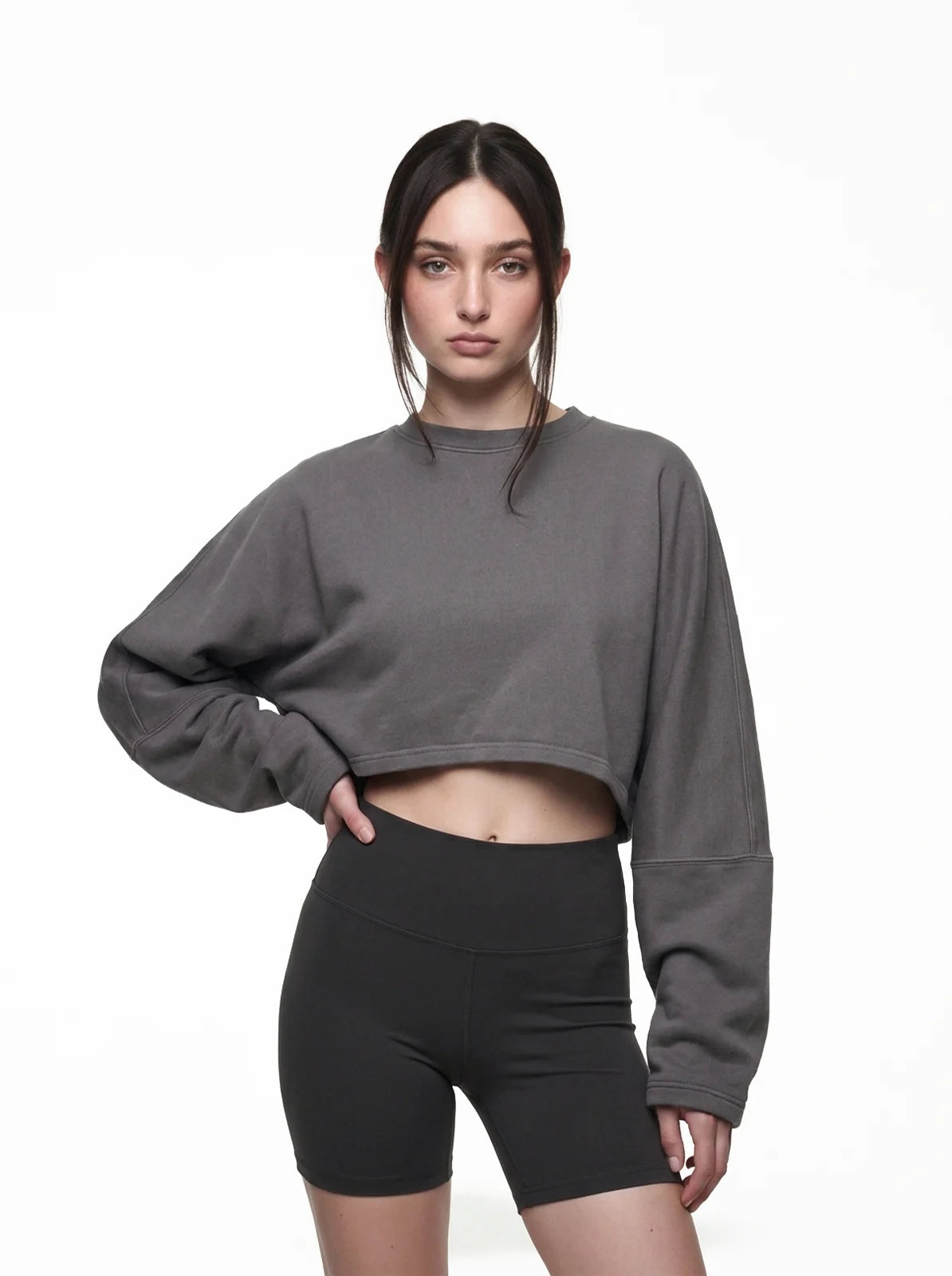 Woman wearing dark grey cult cover crop tee