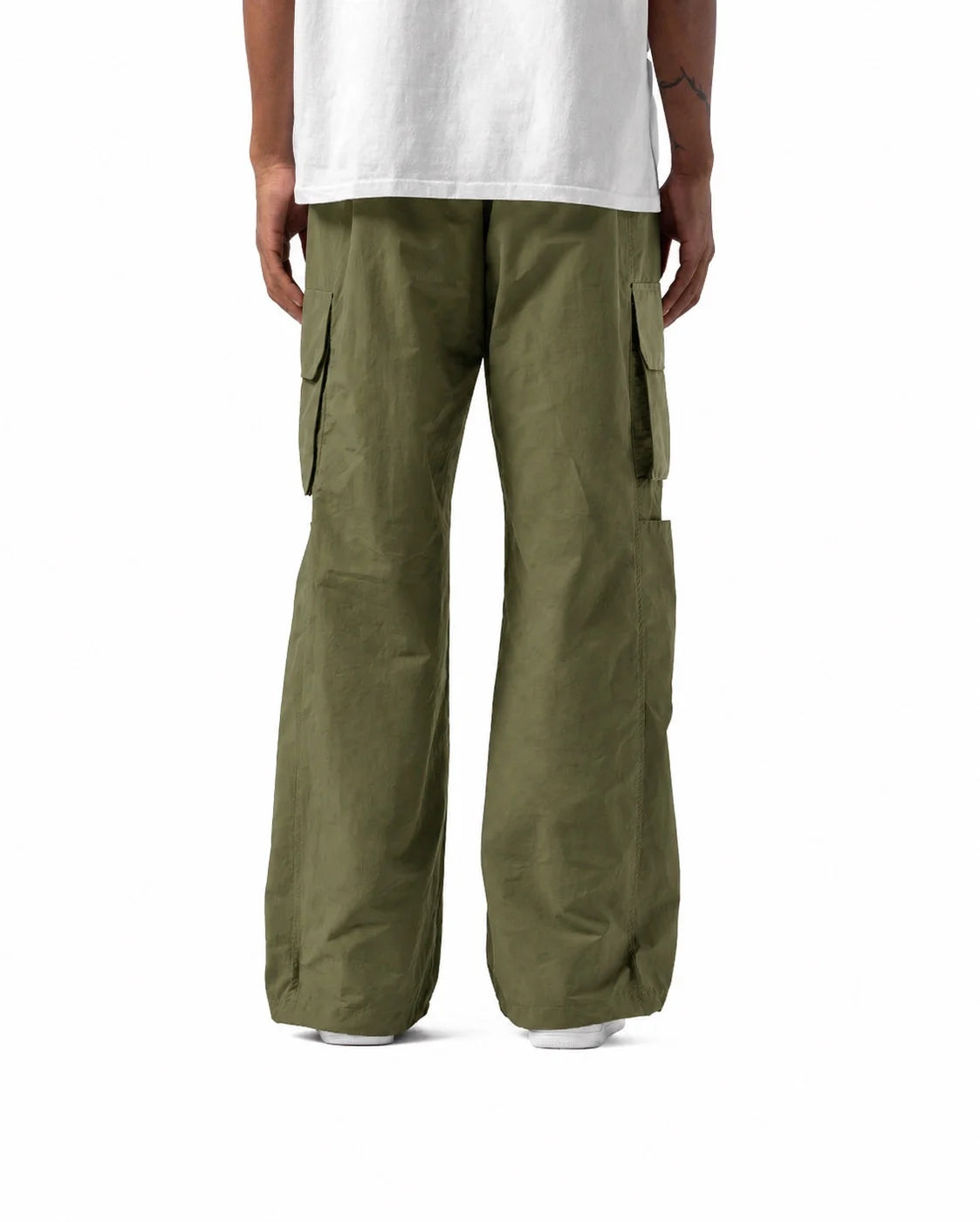 Person wearing olive green cargo pants on a white background