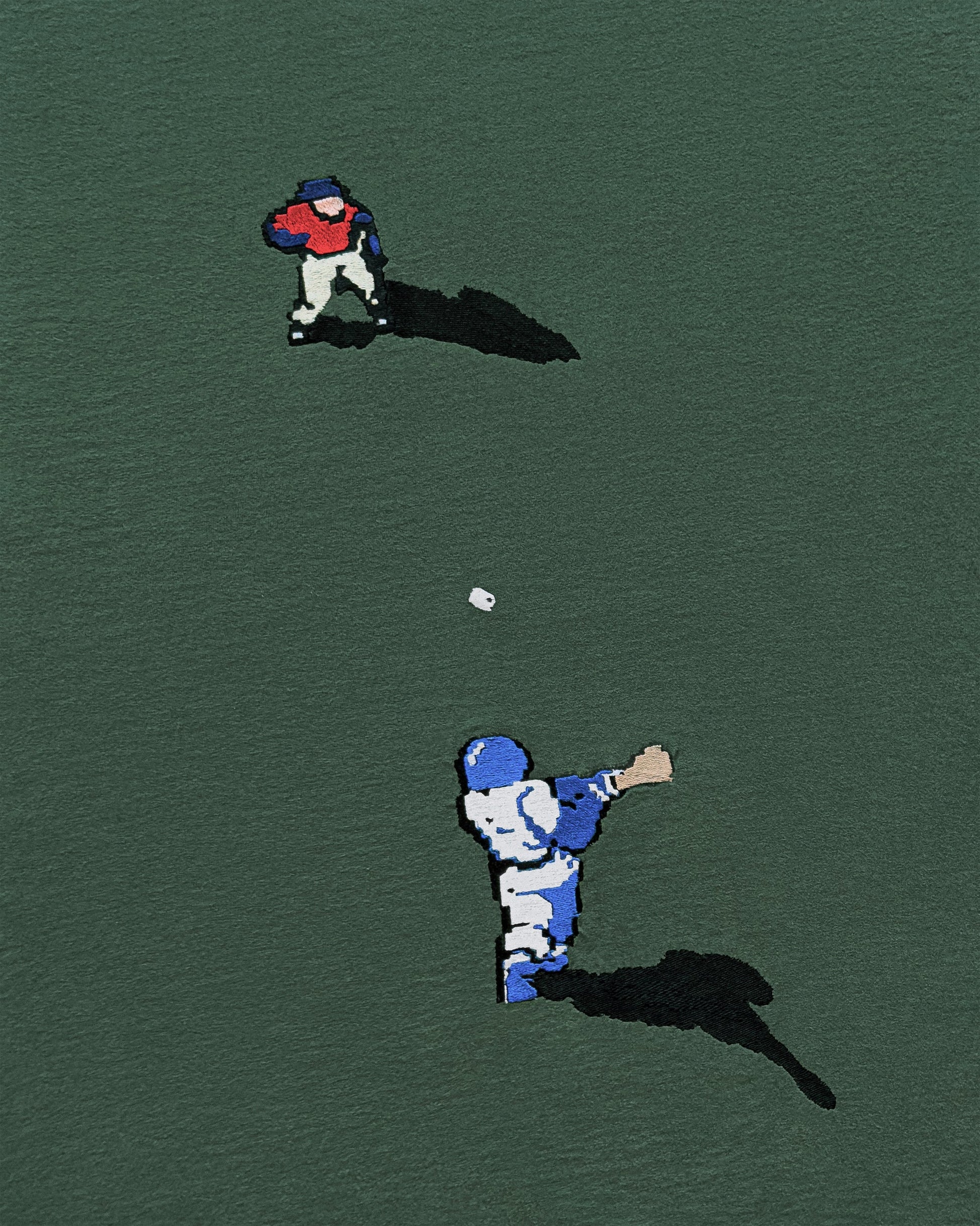 Two embroidered baseball players on a green background