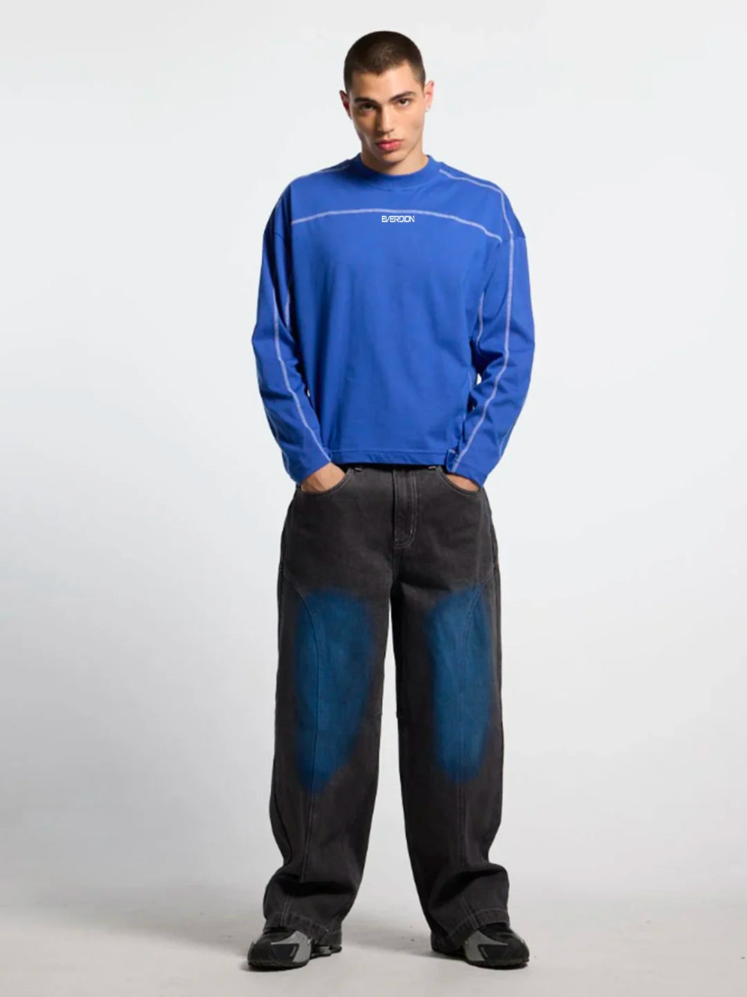 Person wearing a blue long-sleeve t-shirt with white accents 