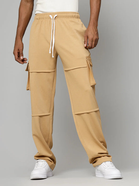 Tan cargo pants worn by a person on a grey background