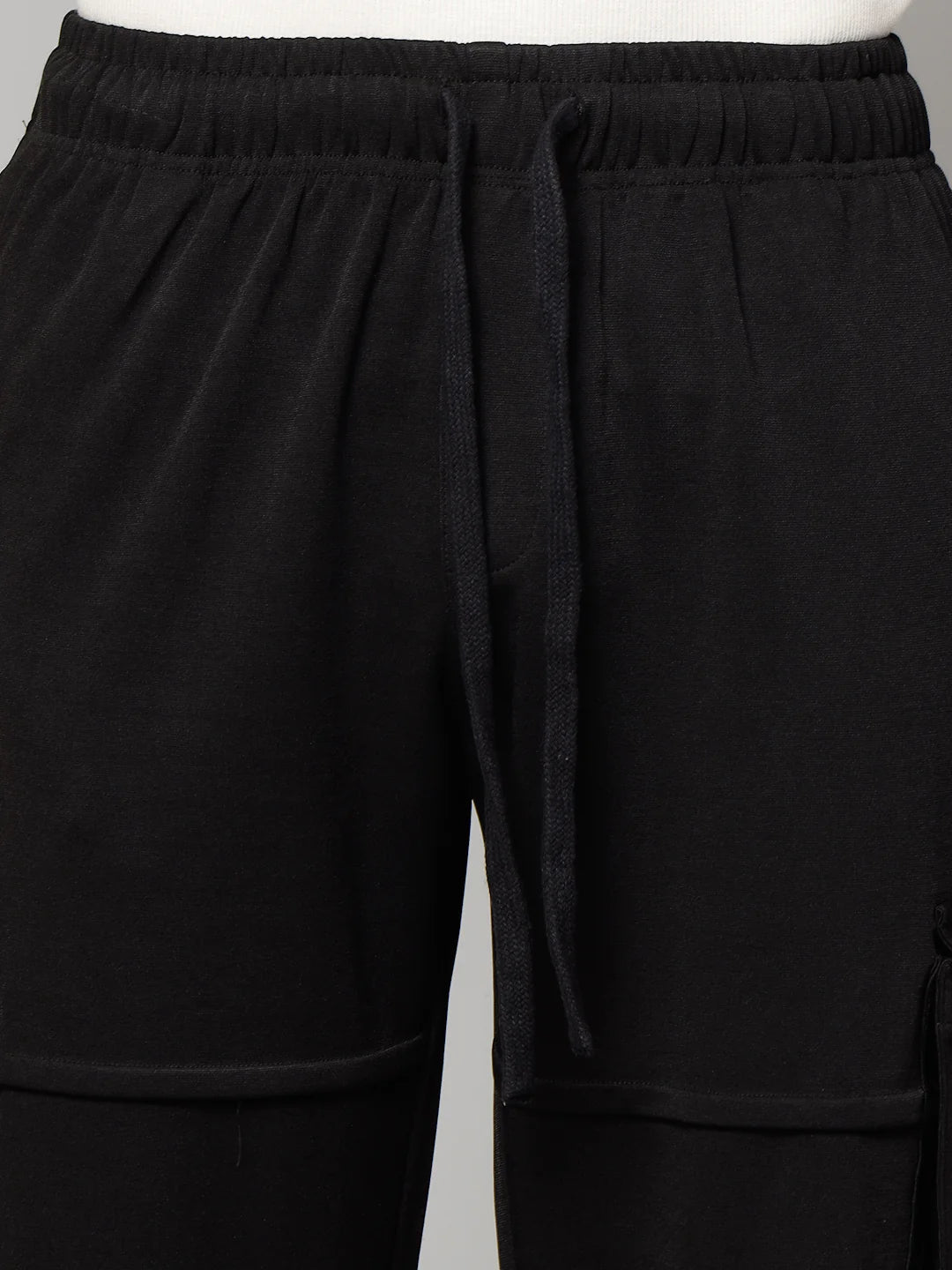 Black cargo pants on a plain background