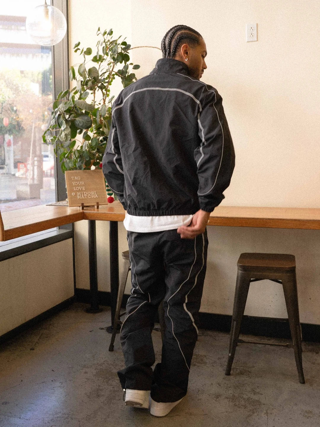 The Black pant delivers a structured yet lightweight feel, while the relaxed-fit track pants ensure fluid movement and all-day comfort. 