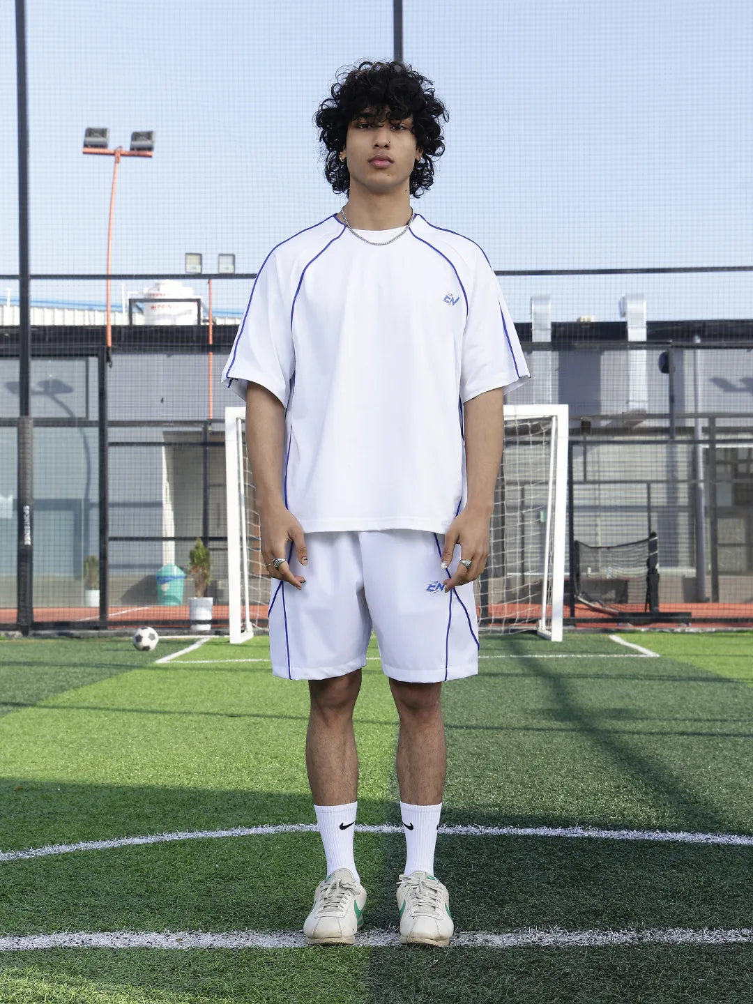 Person wearing a white athletic outfit on a sports field