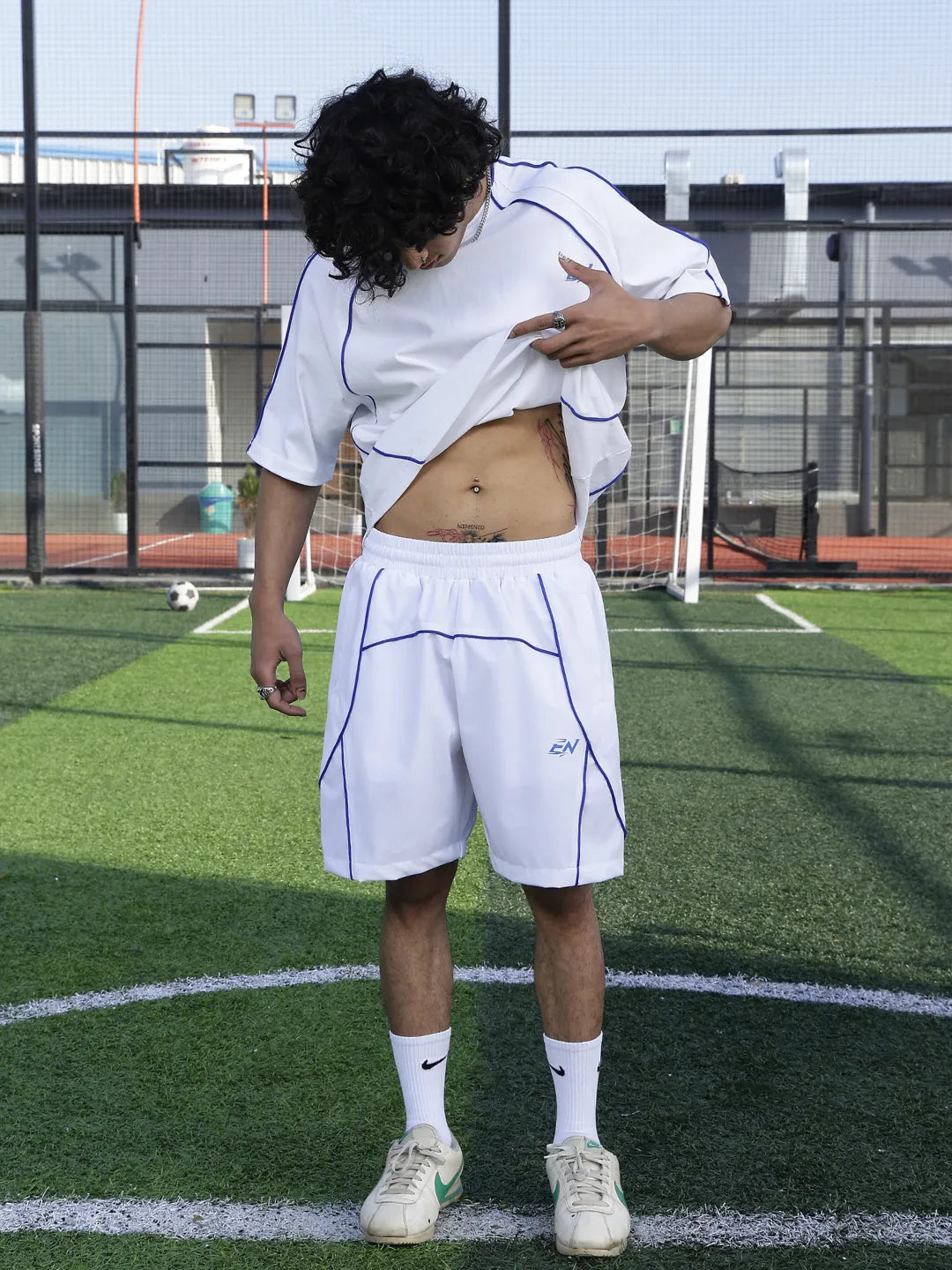 Person wearing a white sports outfit on a soccer field