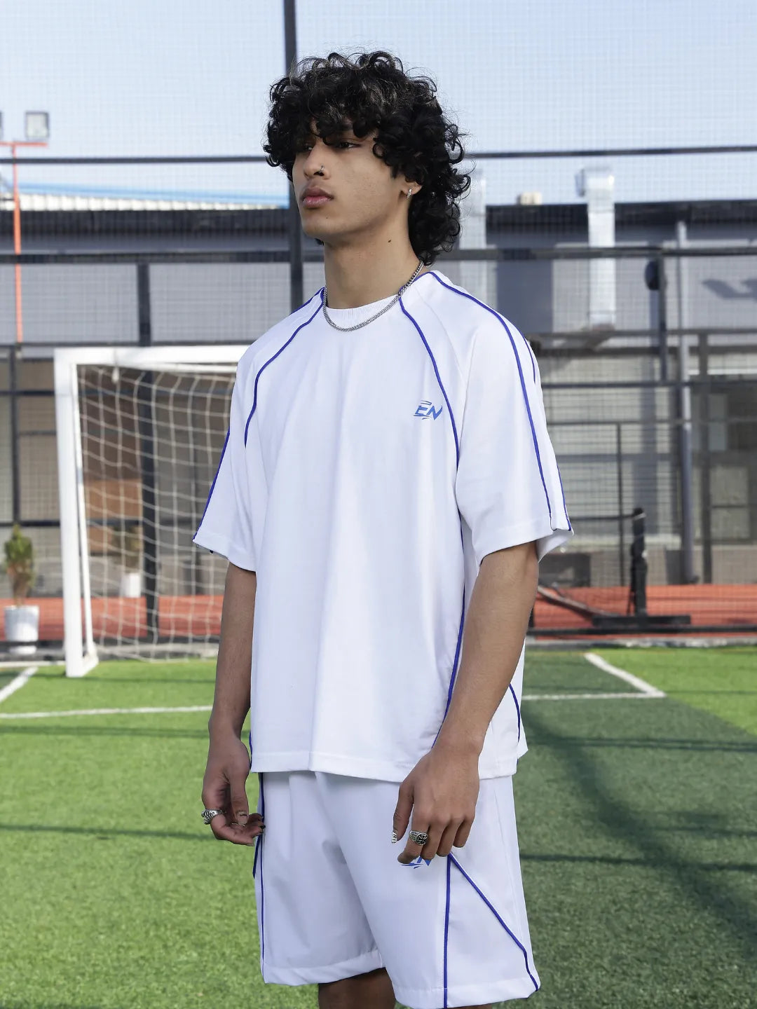 Person wearing a white outfit on a sports field