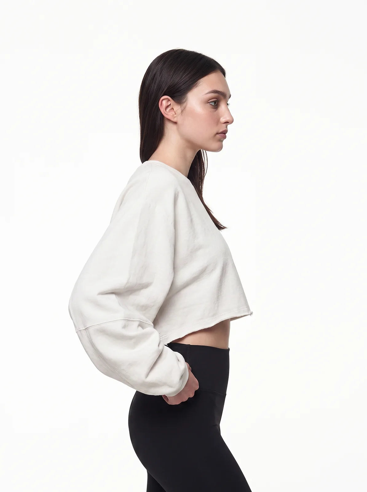Woman wearing white cult cover crop tee