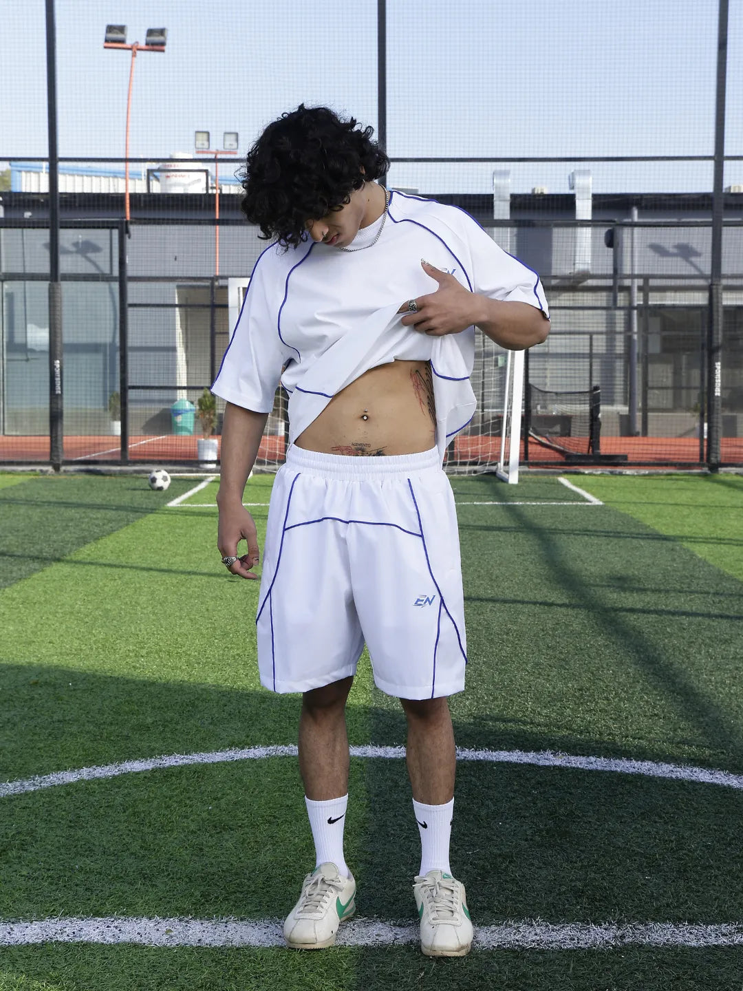 Person wearing a white outfit on a sports field