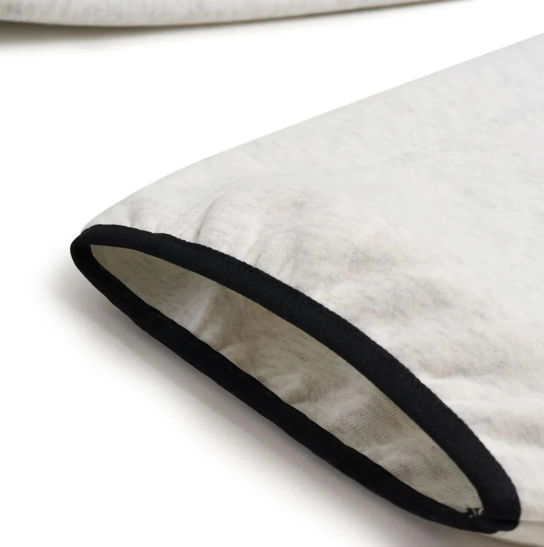 Close-up of a white pillow with a black rim on a white background