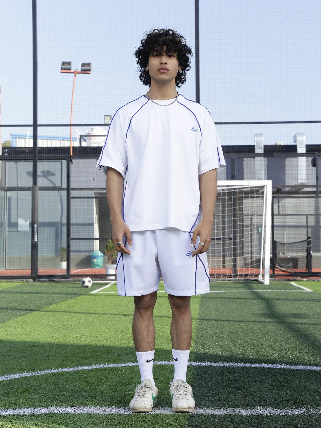 Person wearing a white outfit on a sports field