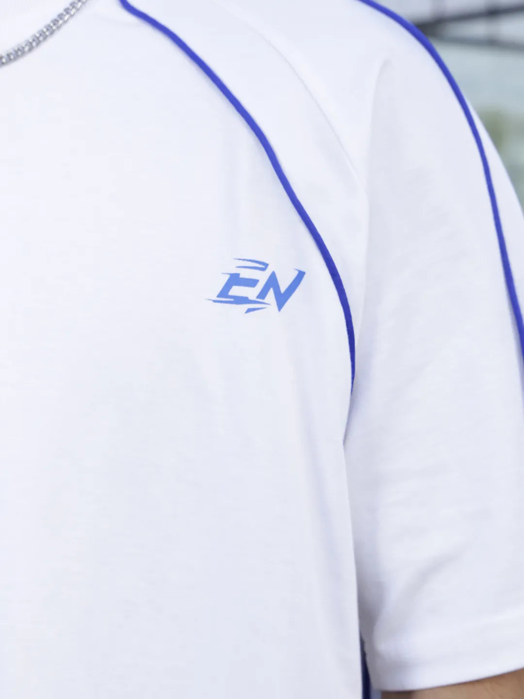 Person wearing a white baseball jersey 