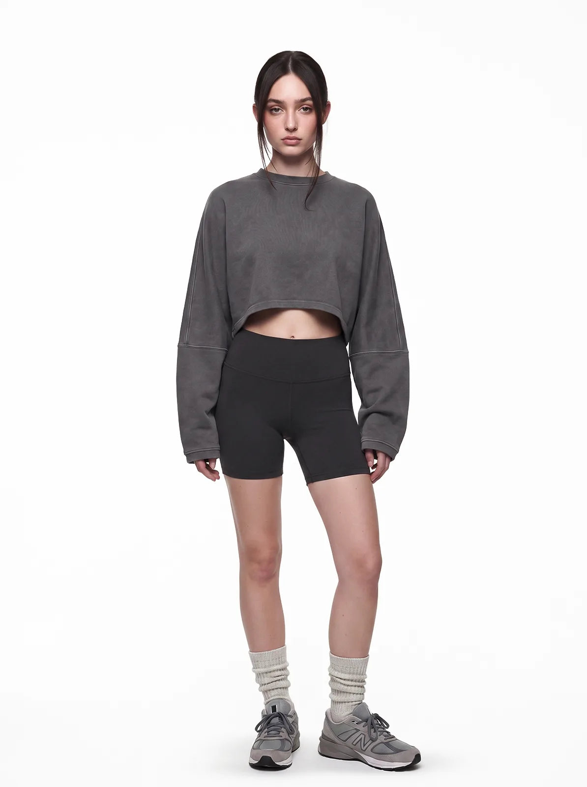 Woman wearing dark grey cult cover crop tee