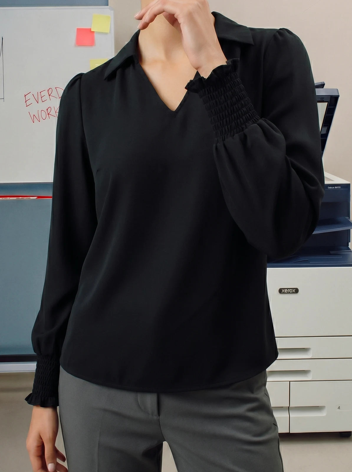 Person wearing a black shirt in an office setting