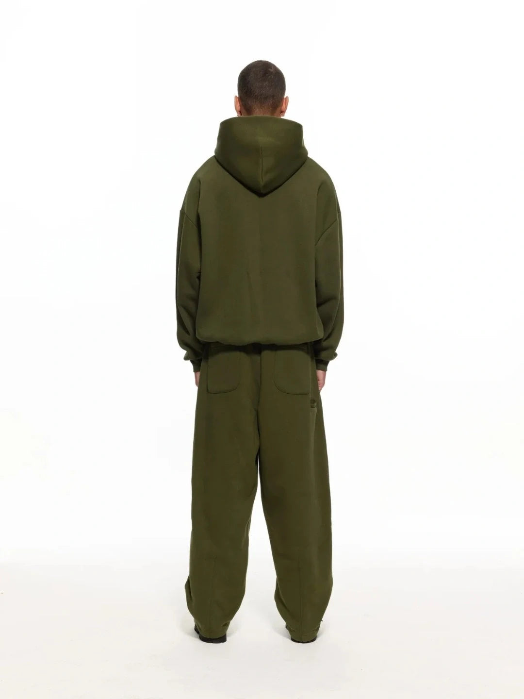 Person wearing a green jumpsuit on a white background