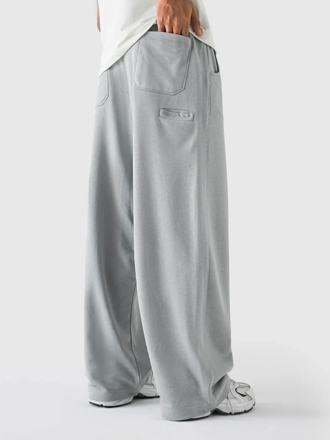 Grey wide-leg pants worn by a person on a white background