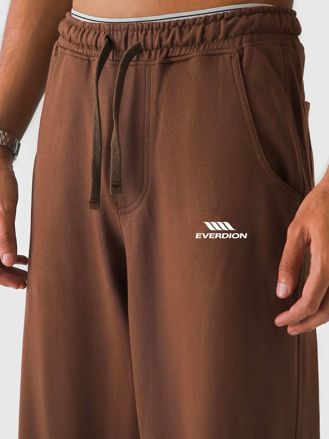 Brown sweatpants with Everdion logo on a plain background